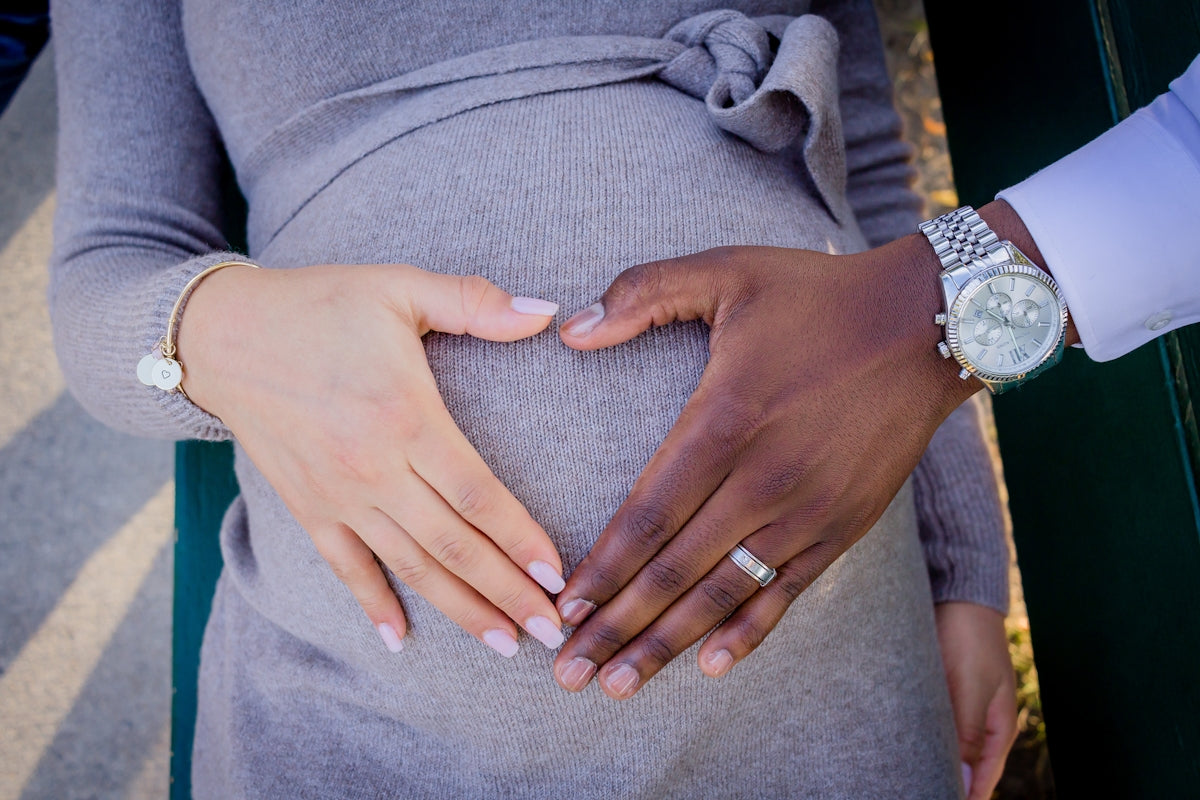 a pregnant woman is holding her husband's hand