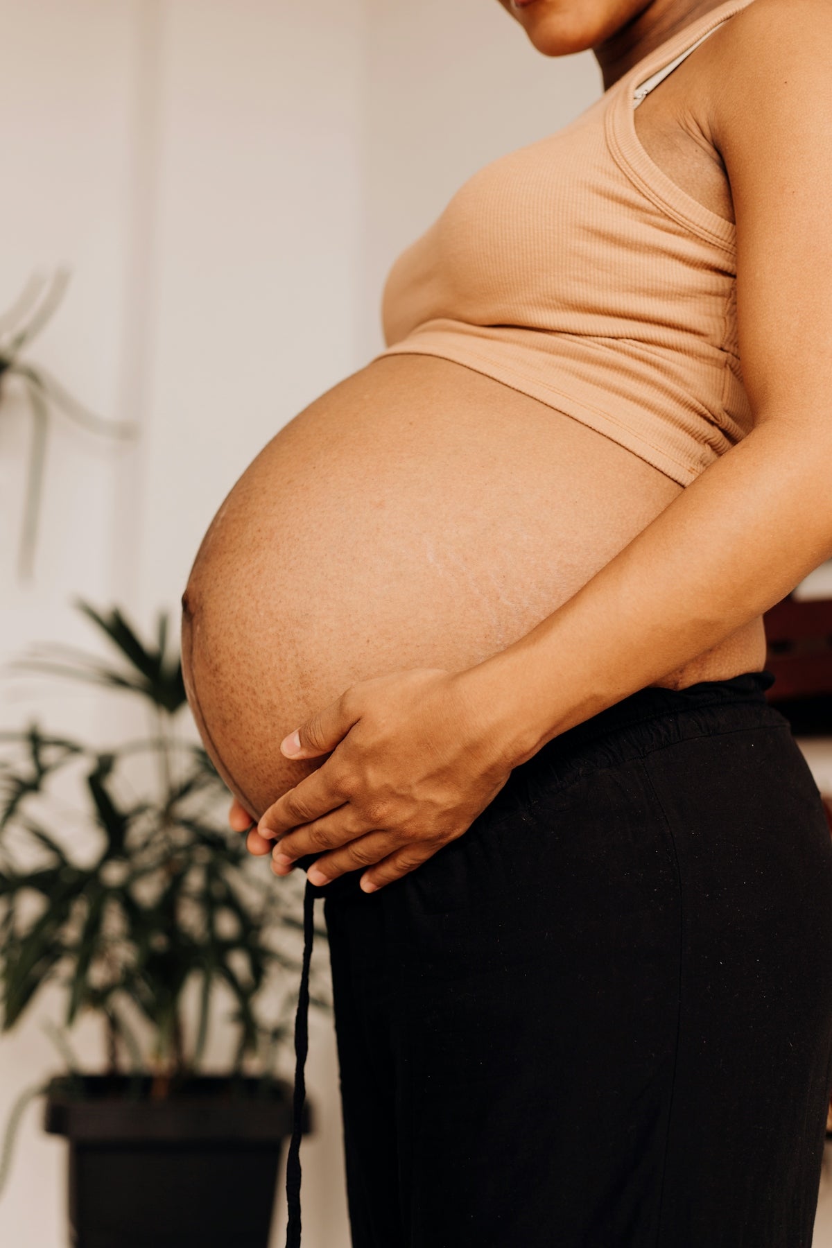 a pregnant woman holding her belly in her hands