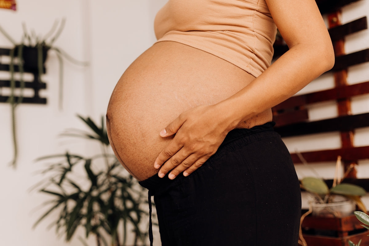 a pregnant woman holding her belly in her hands